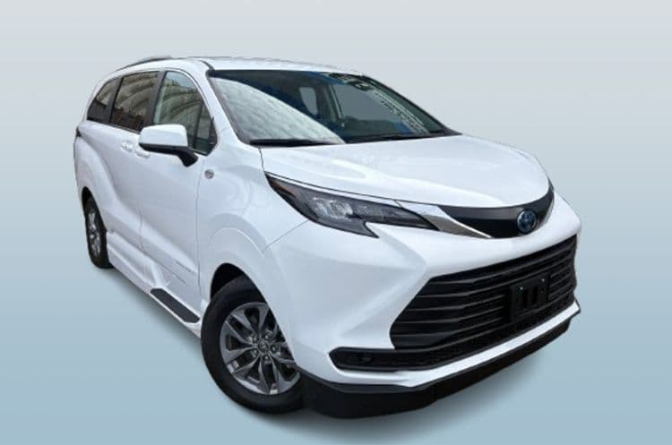 White Toyota Sienna LE, front three-quarter view with the doors closed, photographed against a plain background