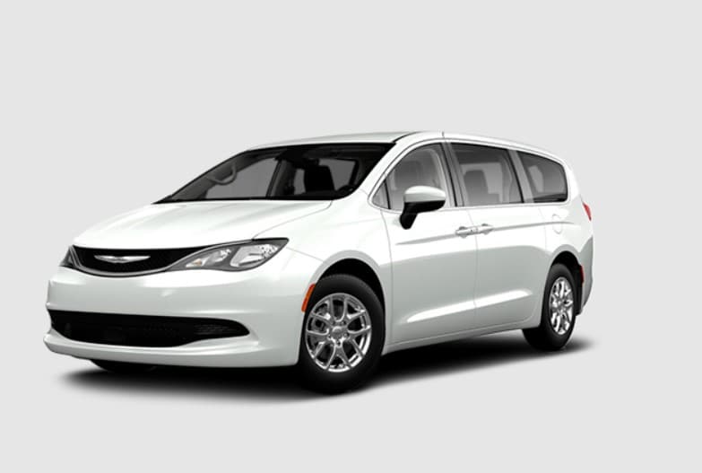 Manufacturer image of the base vehicle before conversion: a Chrysler Grand Caravan SXT in Bright White, front three-quarter view, with no ramp or lowered floor fitted